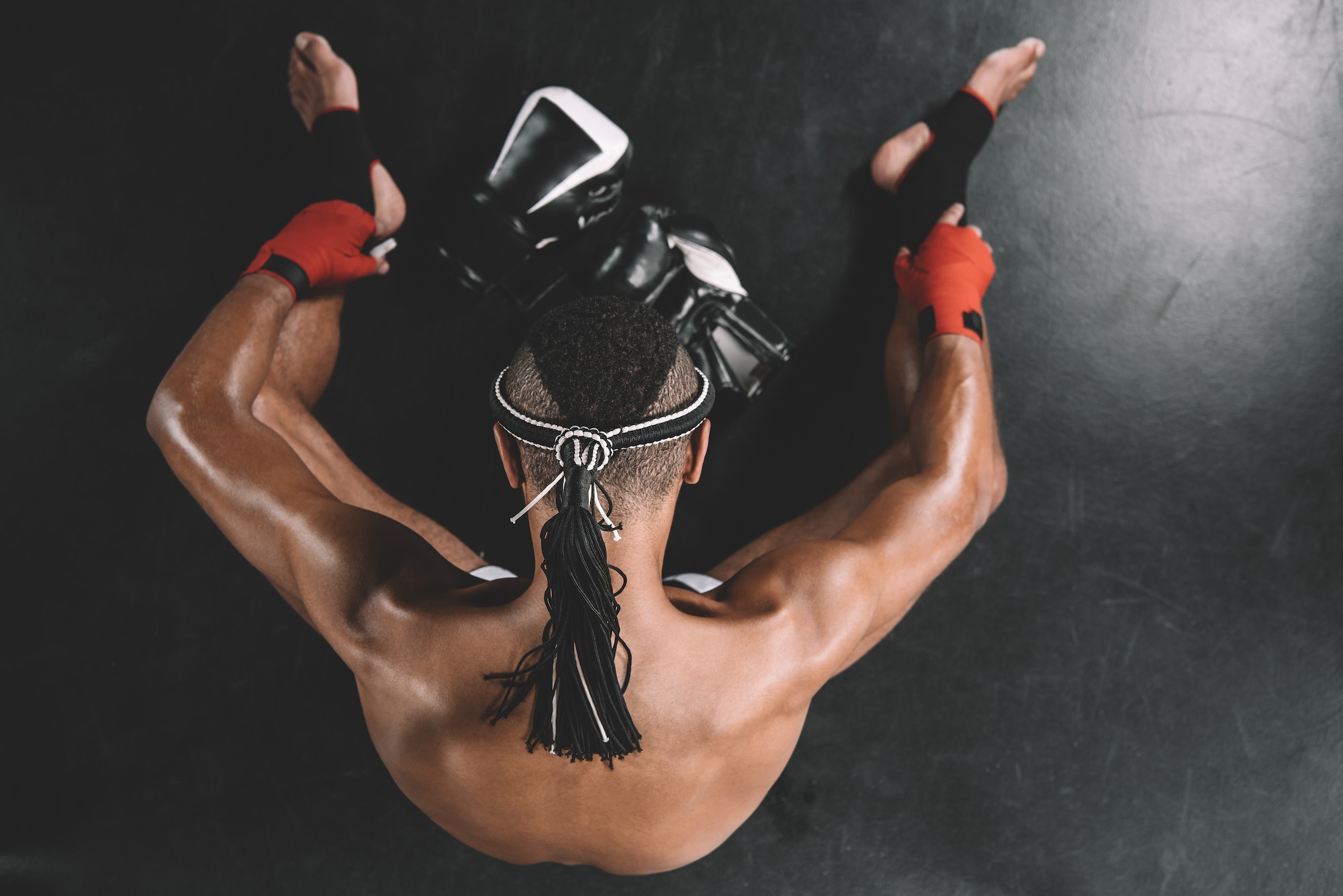 top view on muay thai fighter with mongkhon on head sitting on floor